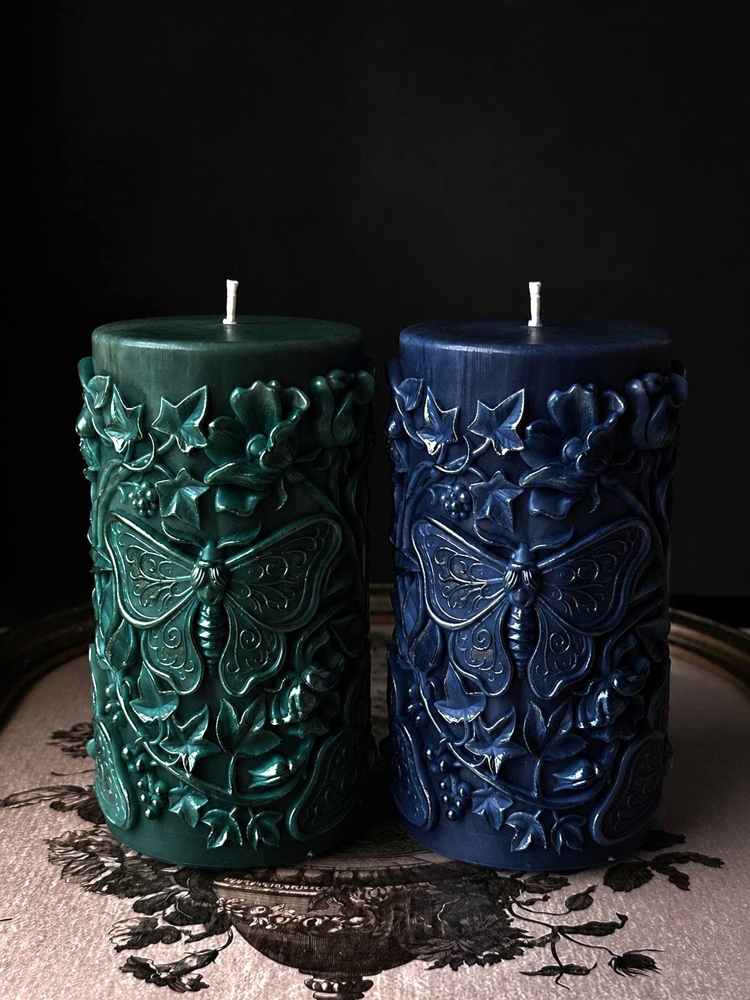 large moth pillar candle made with silicone candle mold on vintage tray