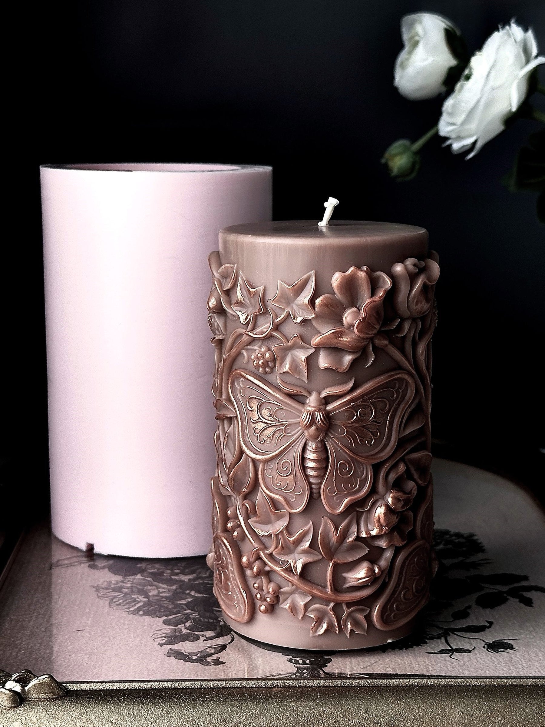 large moth pillar candle made with silicone candle mold on vintage tray